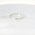 Silver band ring on a white background