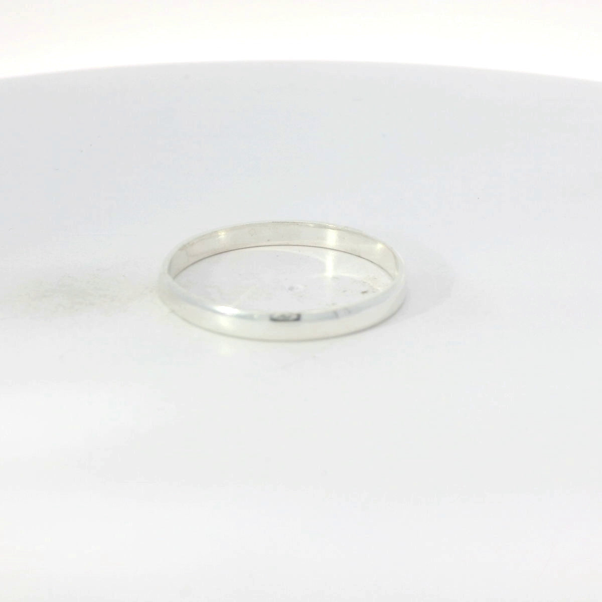 Silver band ring on a white background