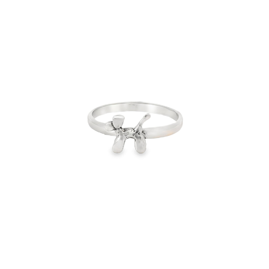 Silver ring with a small design on a white background