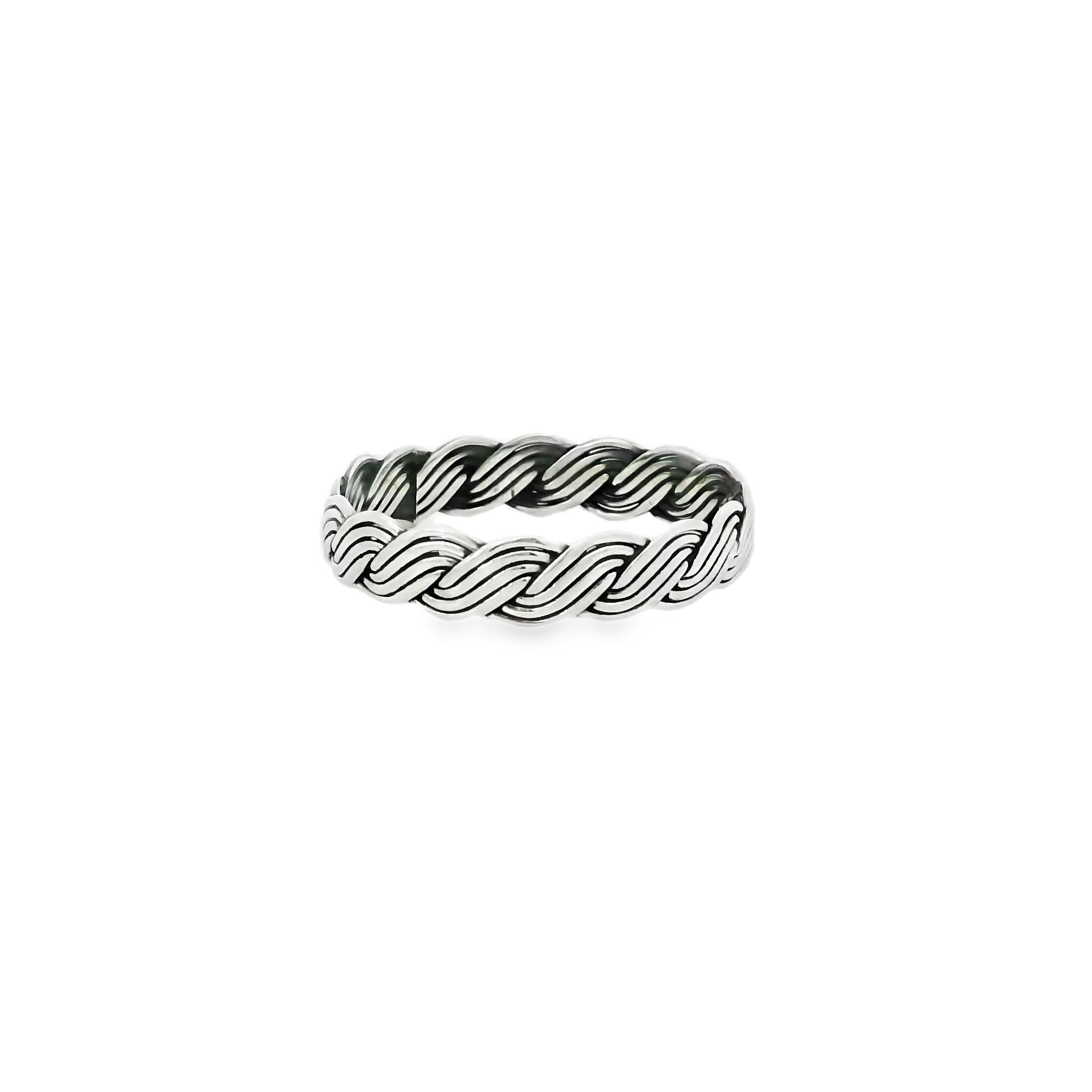 Silver ring with a wavy design on a white background