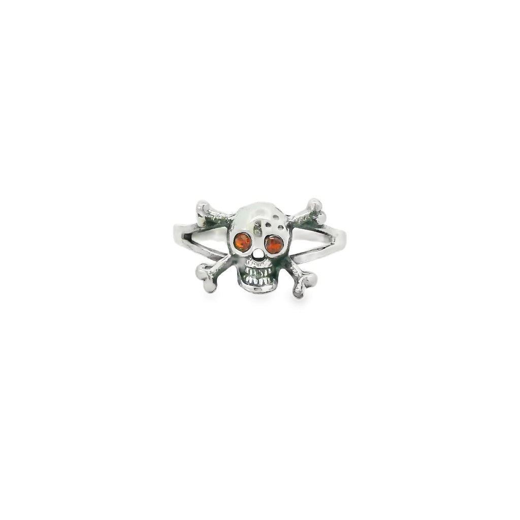 Silver skull and crossbones ring with red eyes on a white background