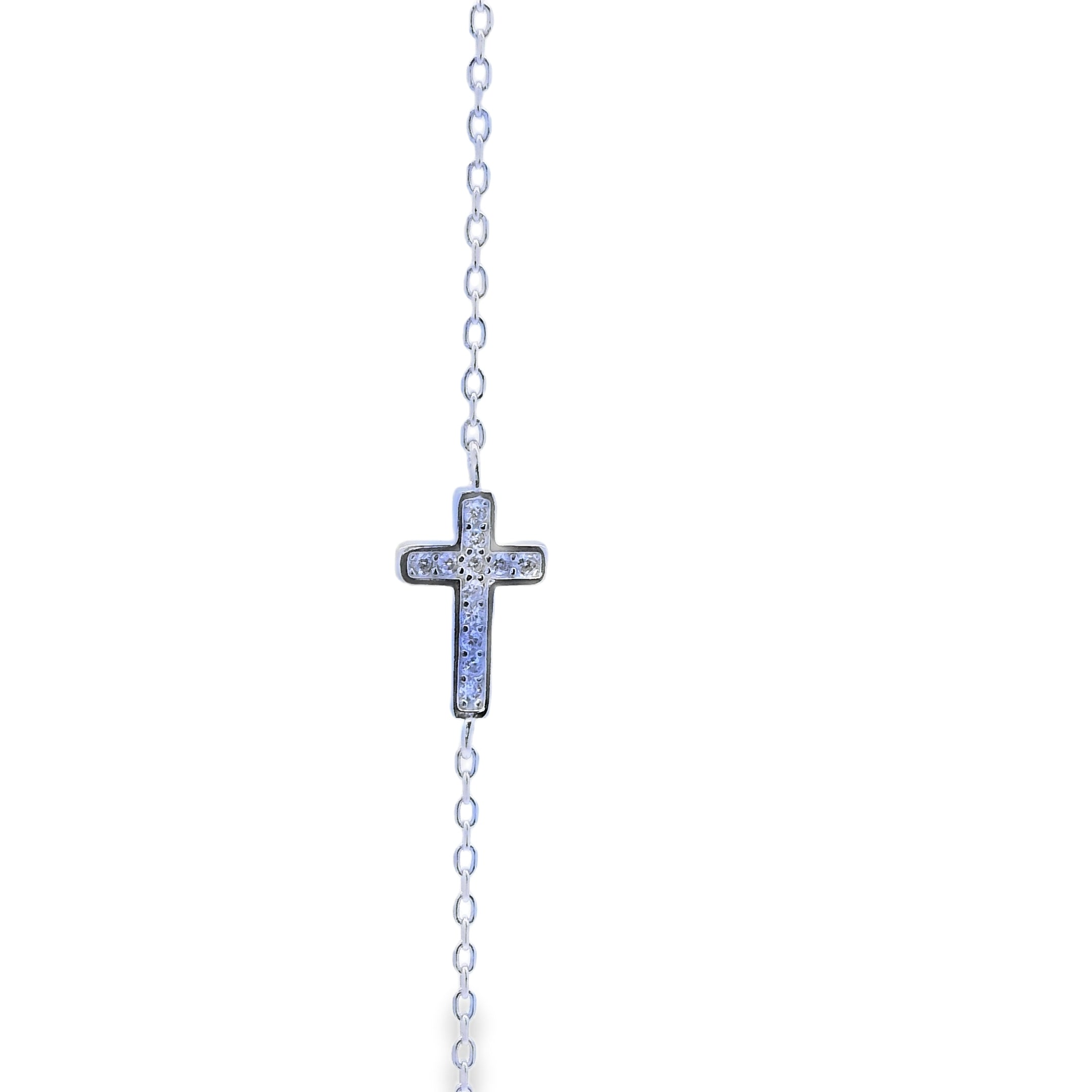 Silver cross necklace on a white background