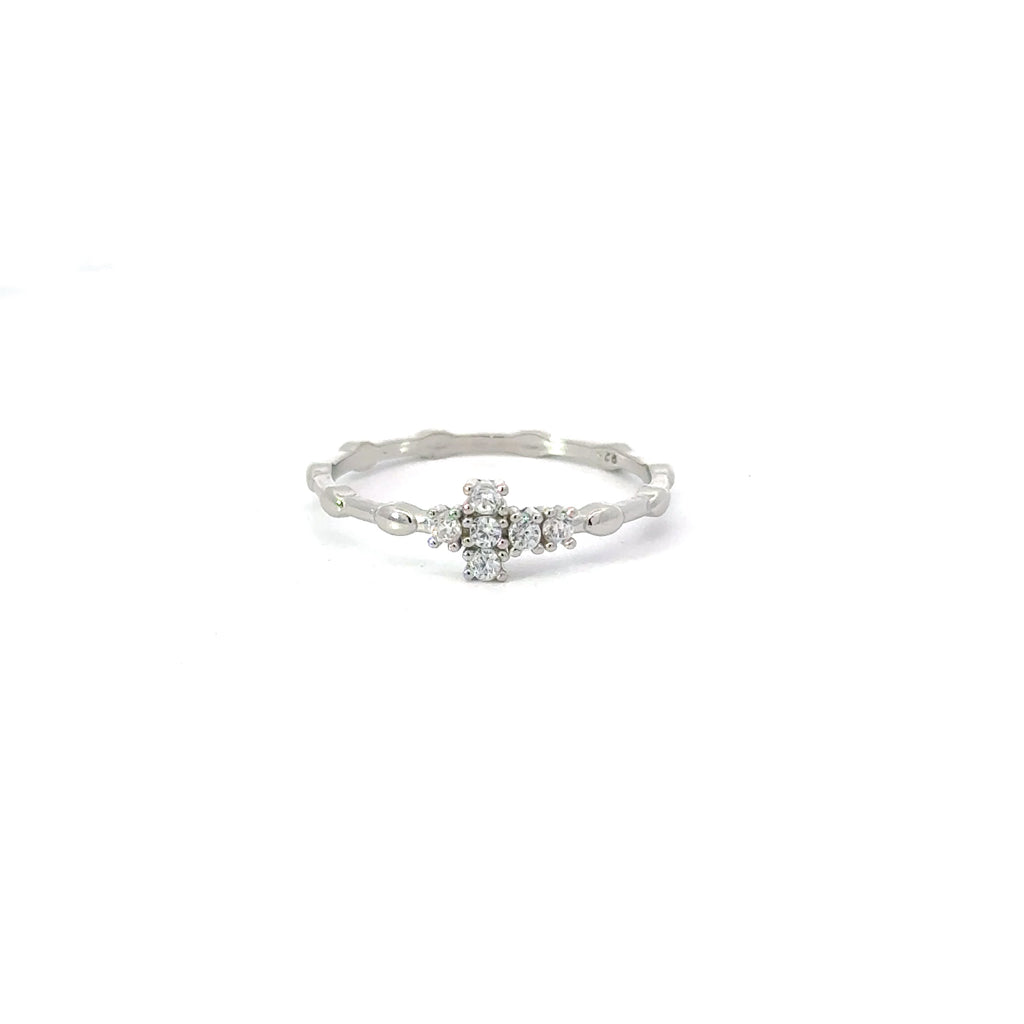 A white cubic zirconia sterling silver ring with a cross design, displayed against a plain background.
