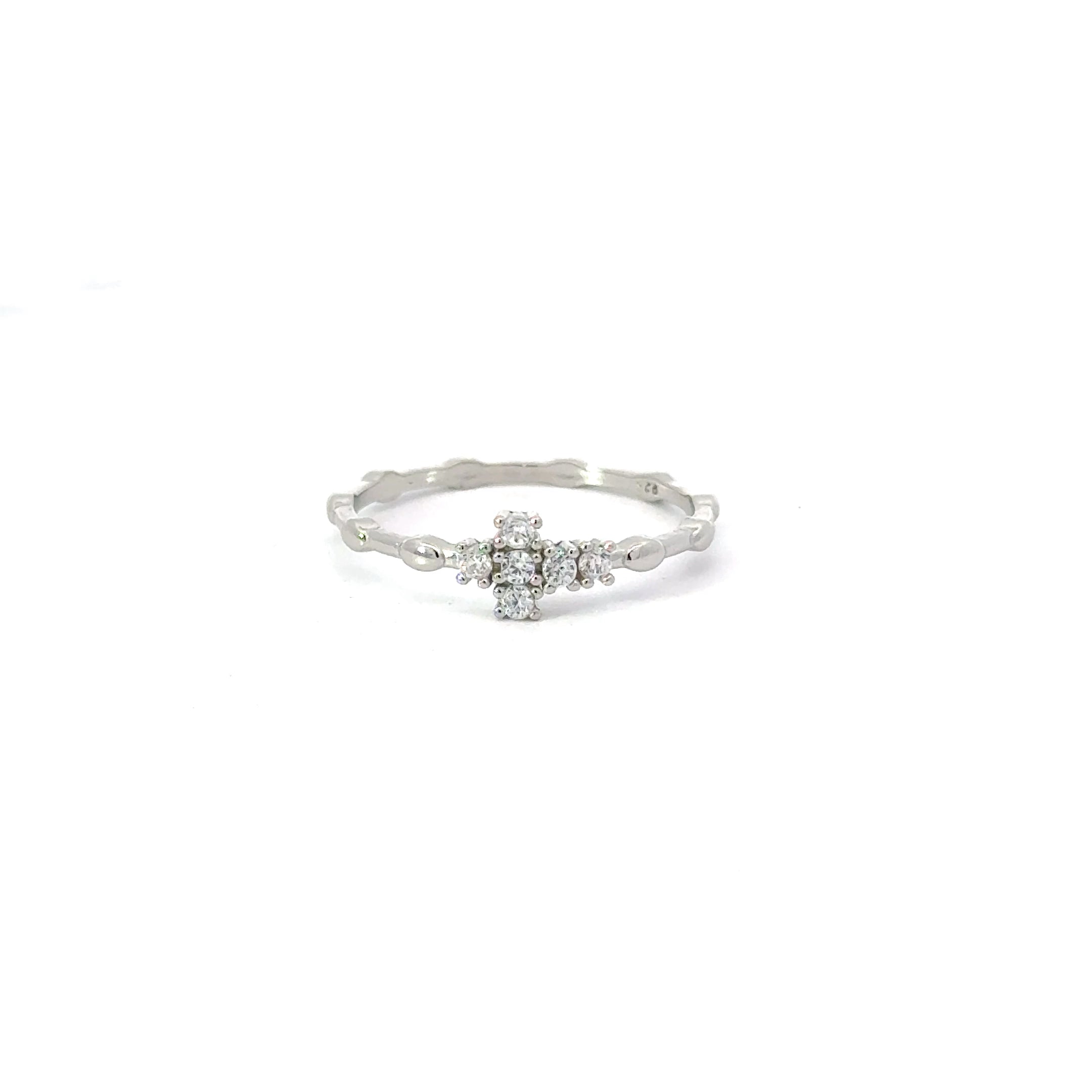 A white cubic zirconia sterling silver ring with a cross design, displayed against a plain background.