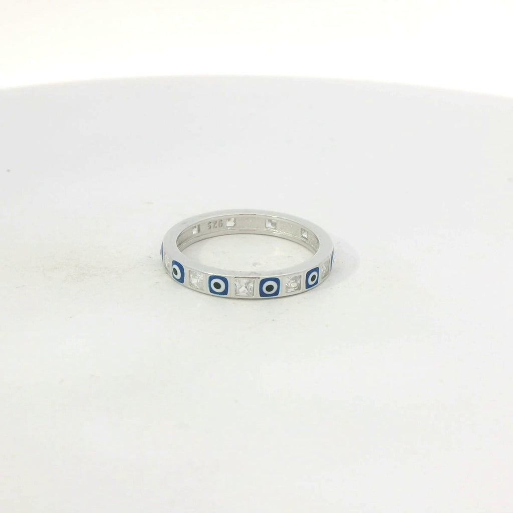Silver ring with blue evil eye on a white background