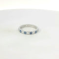 Silver ring with blue evil eye on a white background