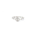 A sterling silver ring with a white cubic zirconia center stone in the shape of a cross, with small silver beads around the band.