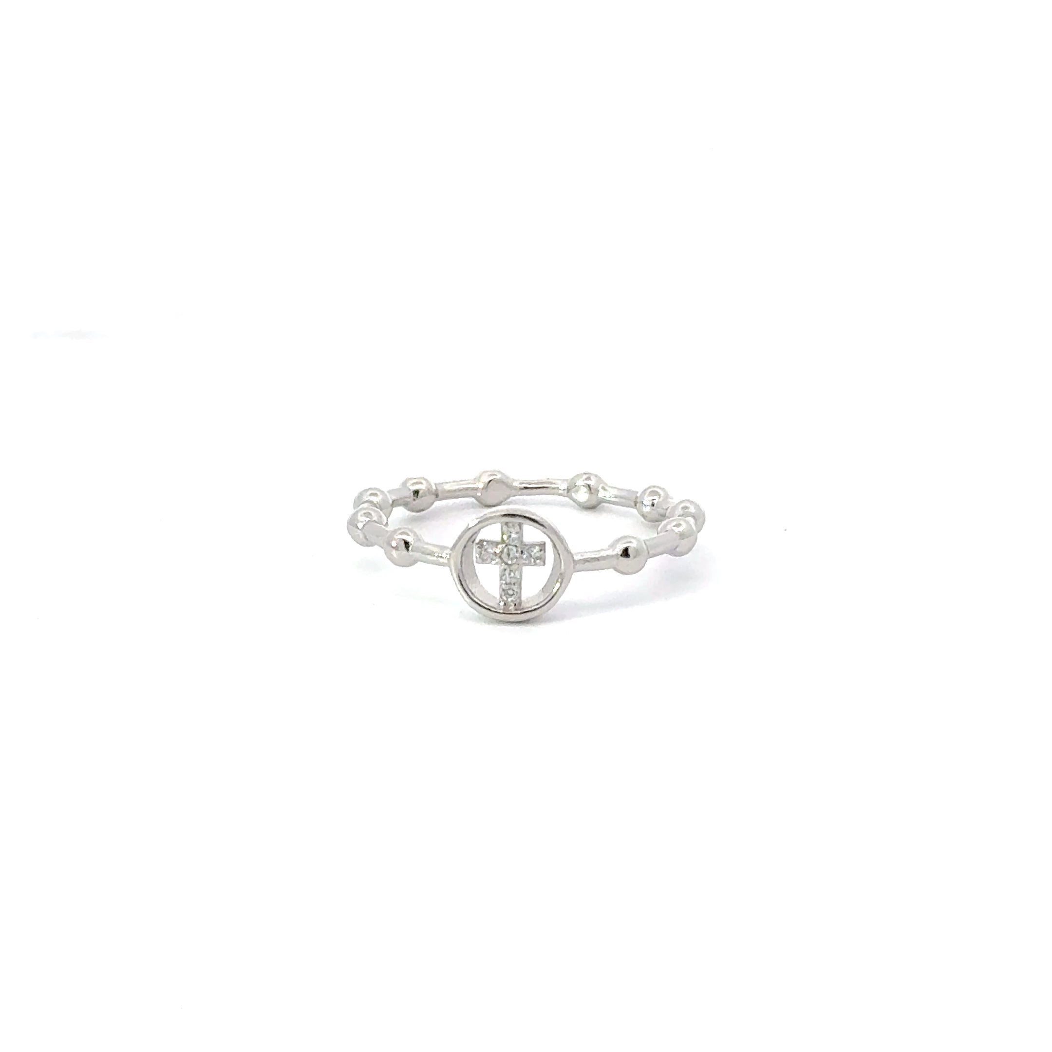 A sterling silver ring with a white cubic zirconia center stone in the shape of a cross, with small silver beads around the band.