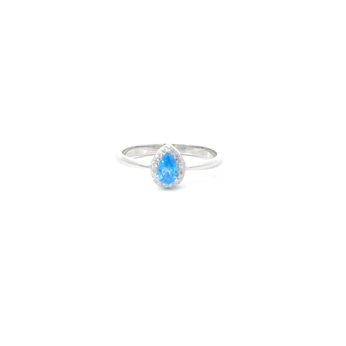 A sterling silver ring with a teardrop-shaped aquamarine cubic zirconia centerpiece, set in a smaller circular frame with smaller clear stones around it.