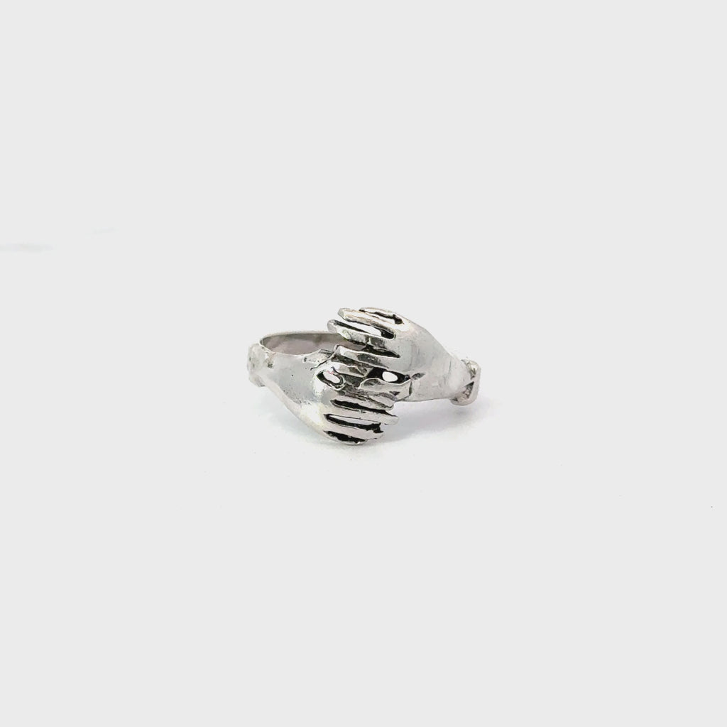 Sterling silver hugging hands ring