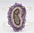 A sterling silver cuff bracelet with a central amethyst geode design.